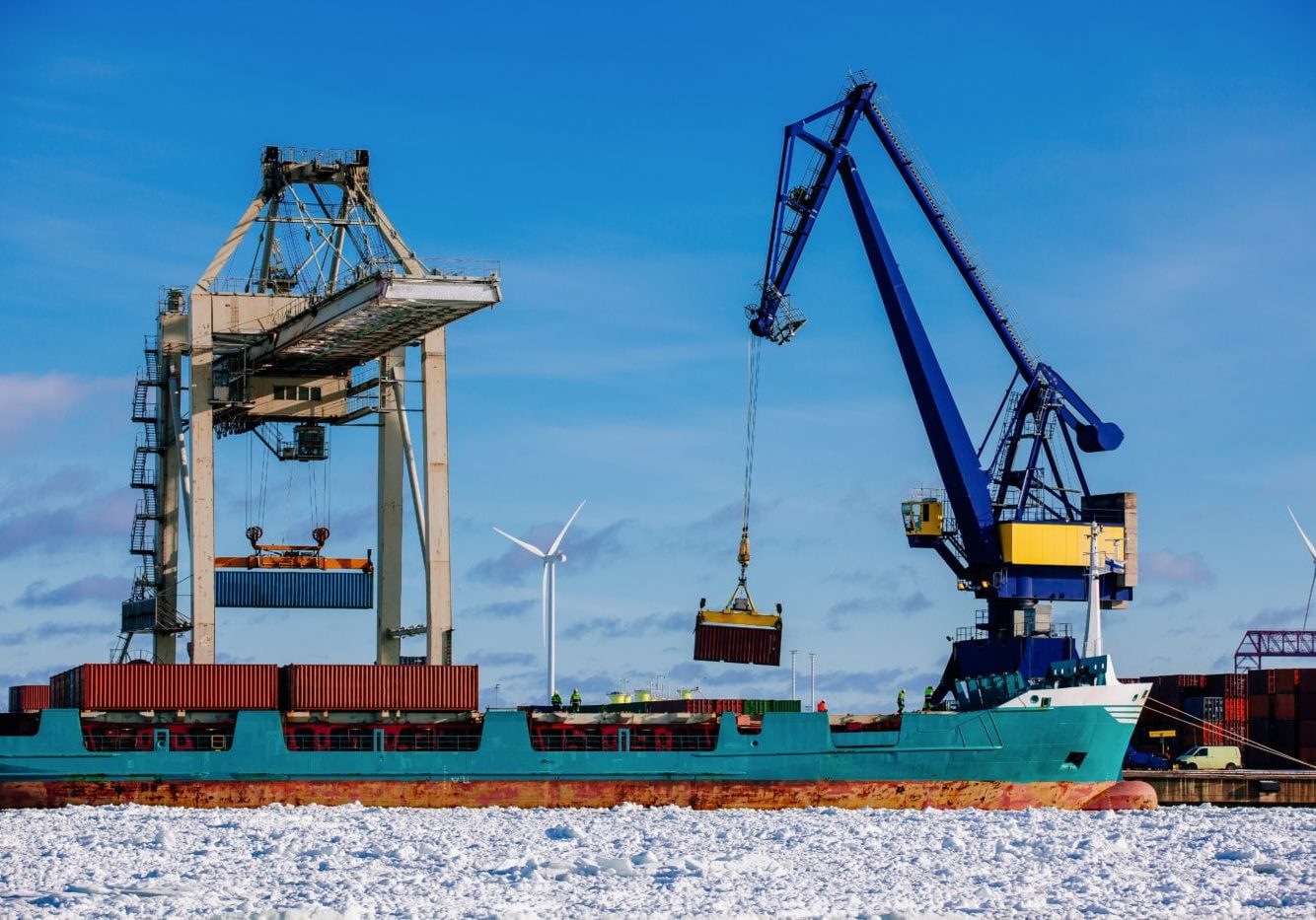 Industrial port with containers, vessel loading in port of Finland Industrial port with containers in winter, vessel loading in port of Finland